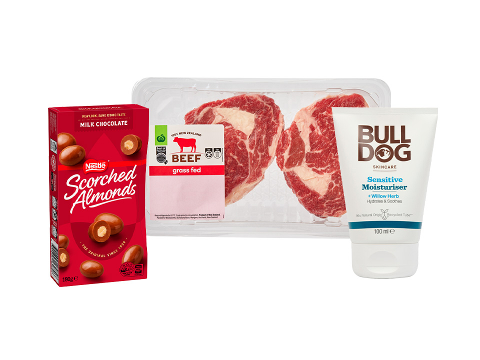 "Happy Father's Day" banner showing a box of Nestlé Scorched Almonds, a tray of raw grass-fed beef steaks, and a tube of Bulldog Sensitive Moisturiser.
