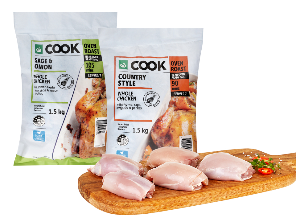 Raw chicken thighs on a wooden board in front of Woolworths Cook Sage & Onion and Country Style oven roast whole chicken bags.