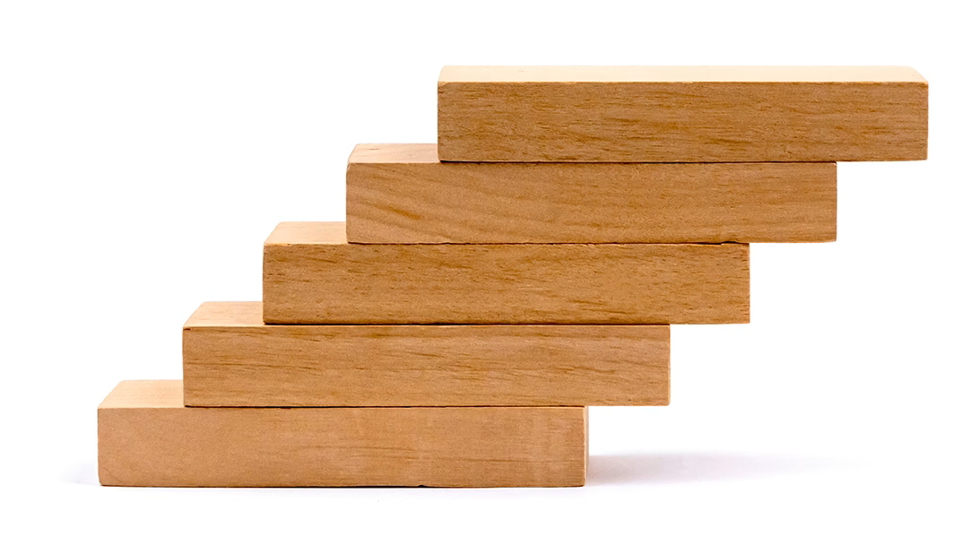 Stack of brown wooden blocks on a white background
