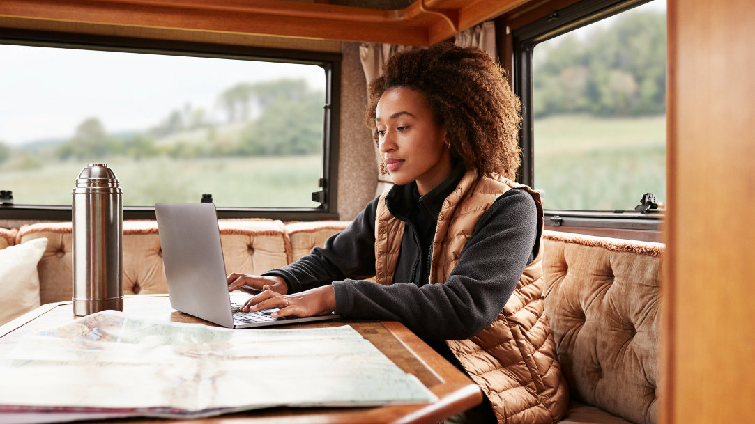 A young person using Copilot for blogging on her Windows laptop while working remotely