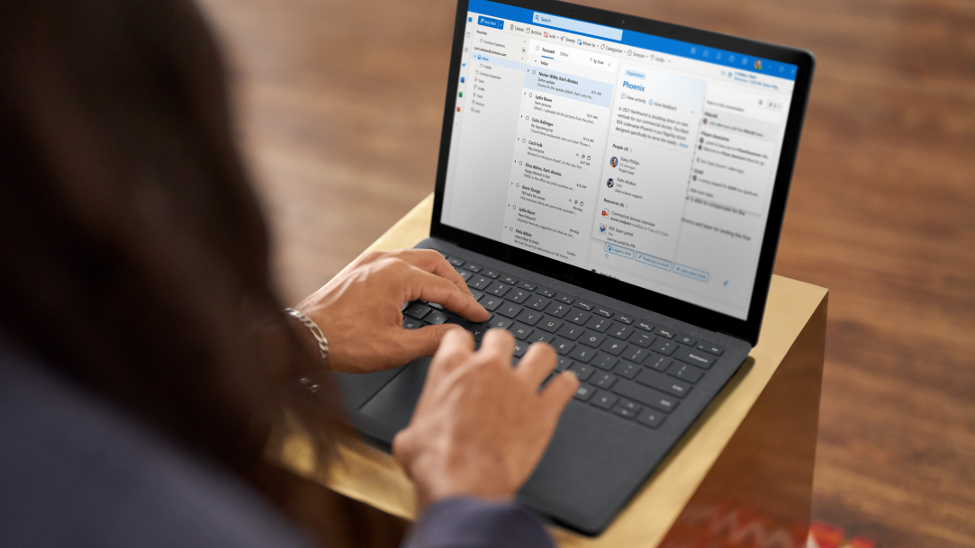 A woman typing emails on her laptop