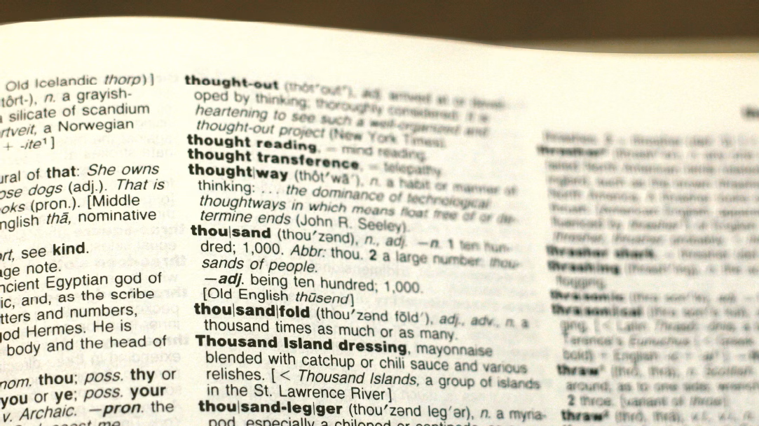 A photo of a dictionary page open to the entries starting with “th”