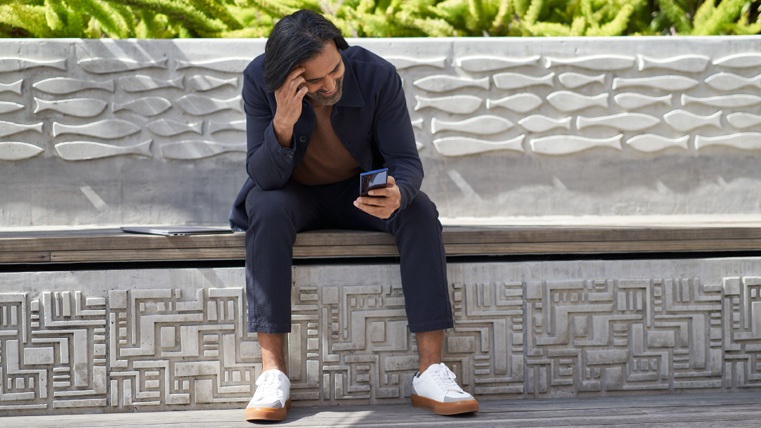 A man tapping on his smartphone