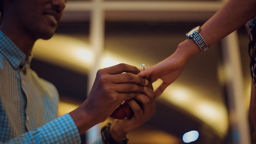 A person places a ring on their partner’s hand