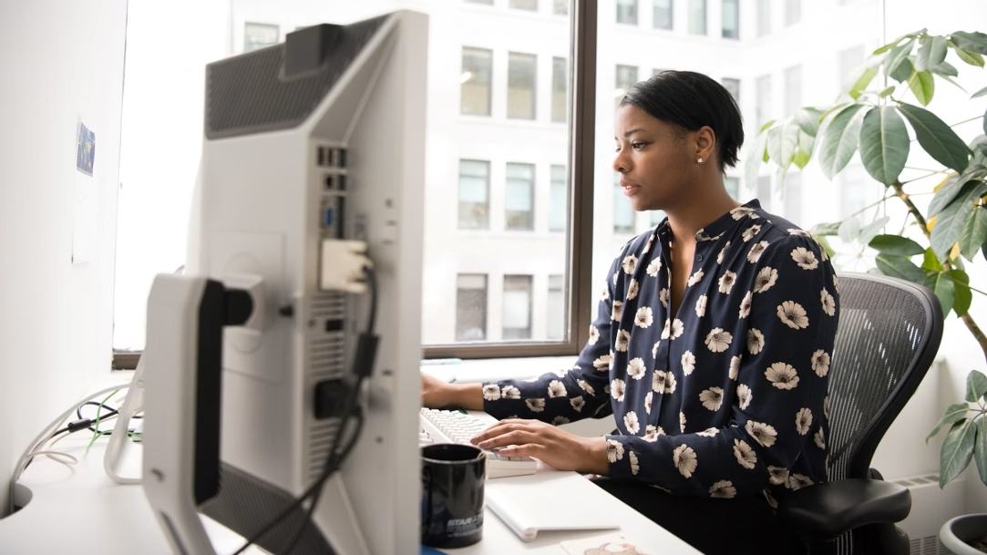 Woman sitting at desk using computer