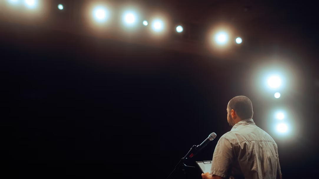 A man standing at a podium in an auditorium