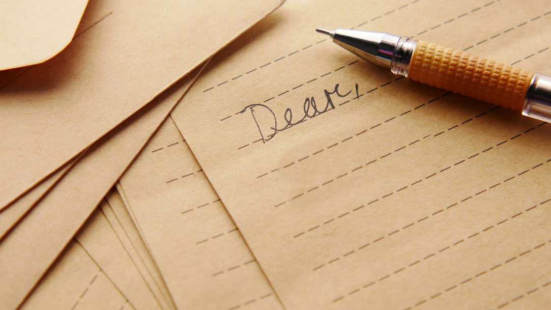 A mechanical pencil sitting on top of a piece of lined paper