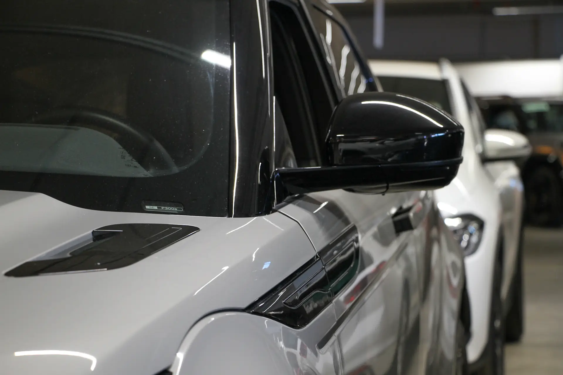 Kuva Range Rover Evoquesta keulan suunnasta, jossa autosta näkyy musta sivupeili ja hieman kuljettajan puolen kylkiprofiilia