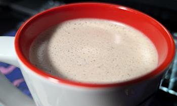 Photo of a coffee with creamer in it