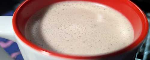 Photo of a coffee with creamer in it