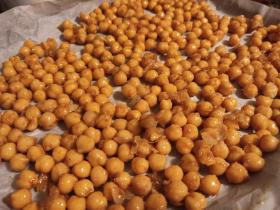 Uncooked chickpeas seasoned in a pan.