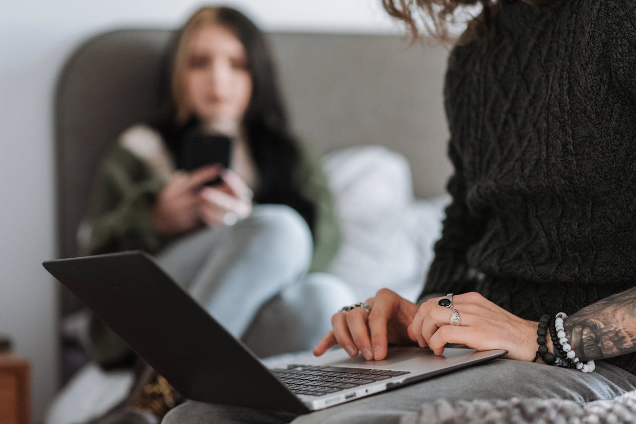 couple-scrolling-on-social-media-while-together-on-a-bed