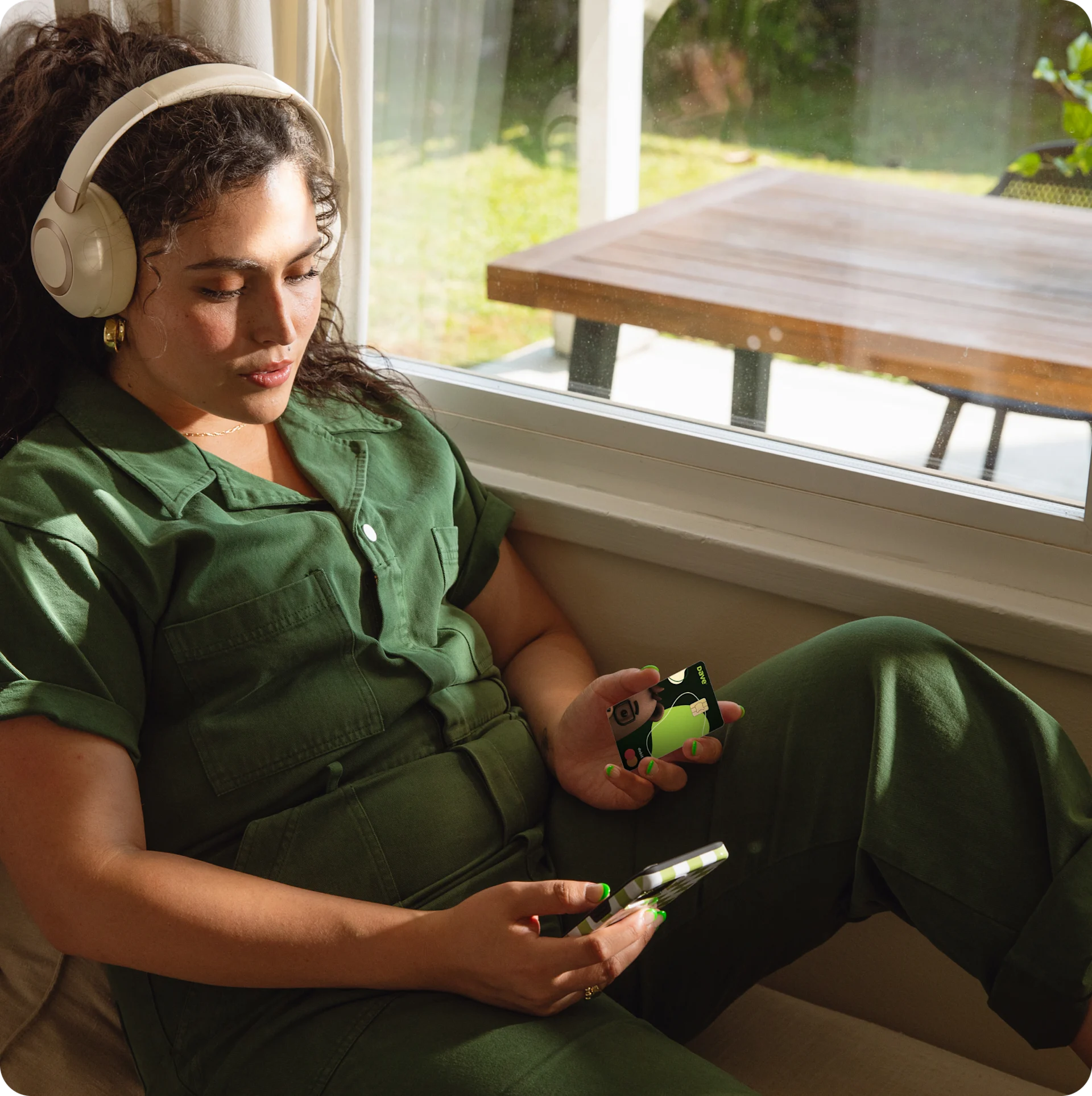 Woman sitting in window with the Dave card
