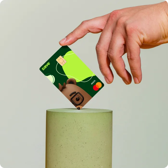 Image of a person touching the Dave card with updated artwork