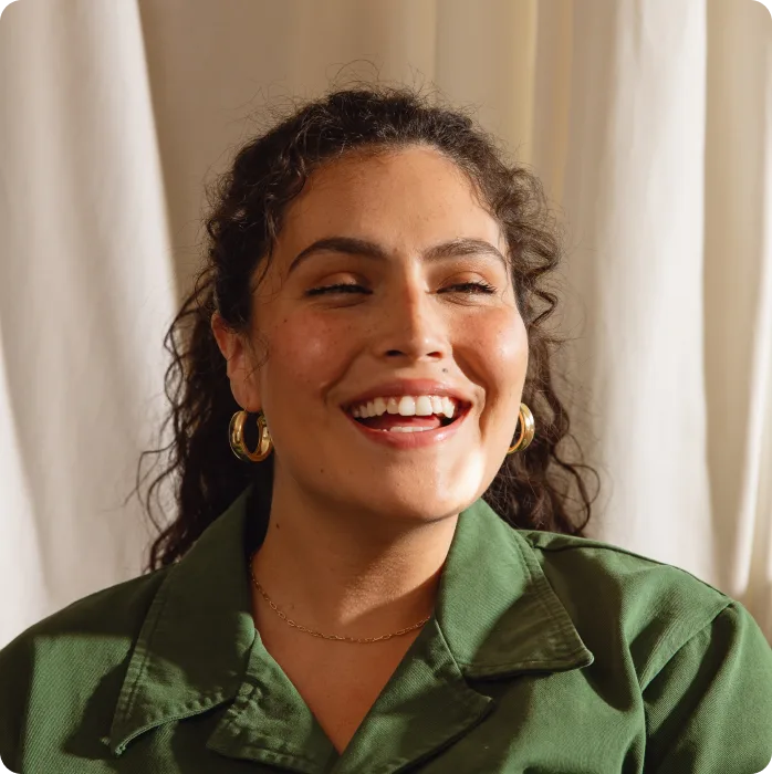 woman in green smiling