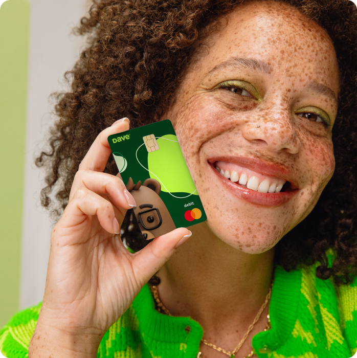 Woman smiling with new Dave debit card