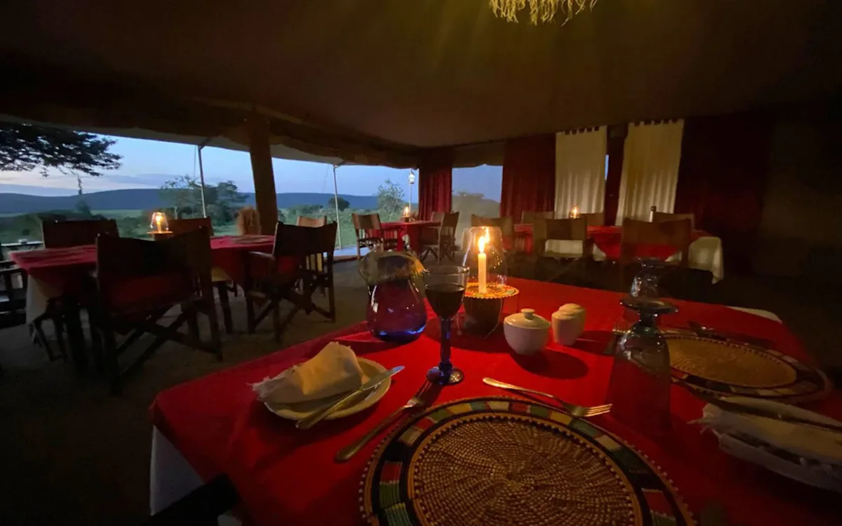 Candlelit dining table with red cloth in the dining tent at Eastern Serengeti Nyumba