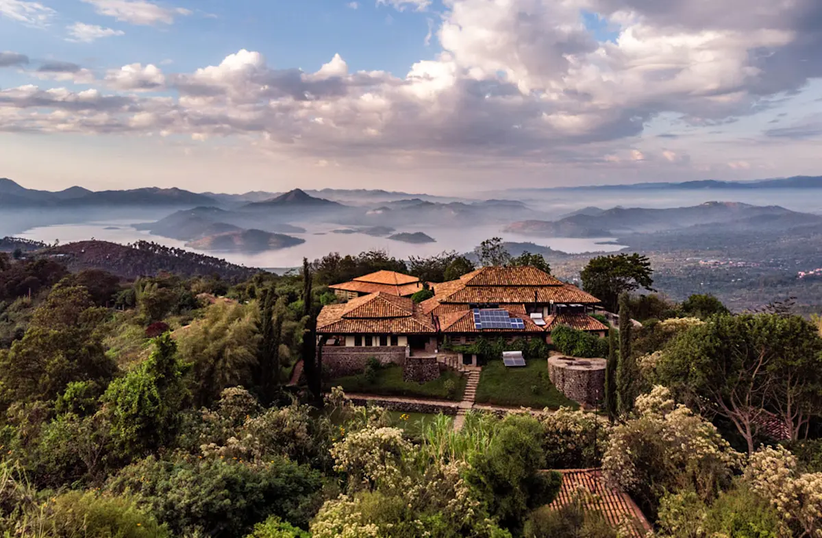 Virunga Lodge on a forested ridge overlooking misty hills and lakes in Rwanda