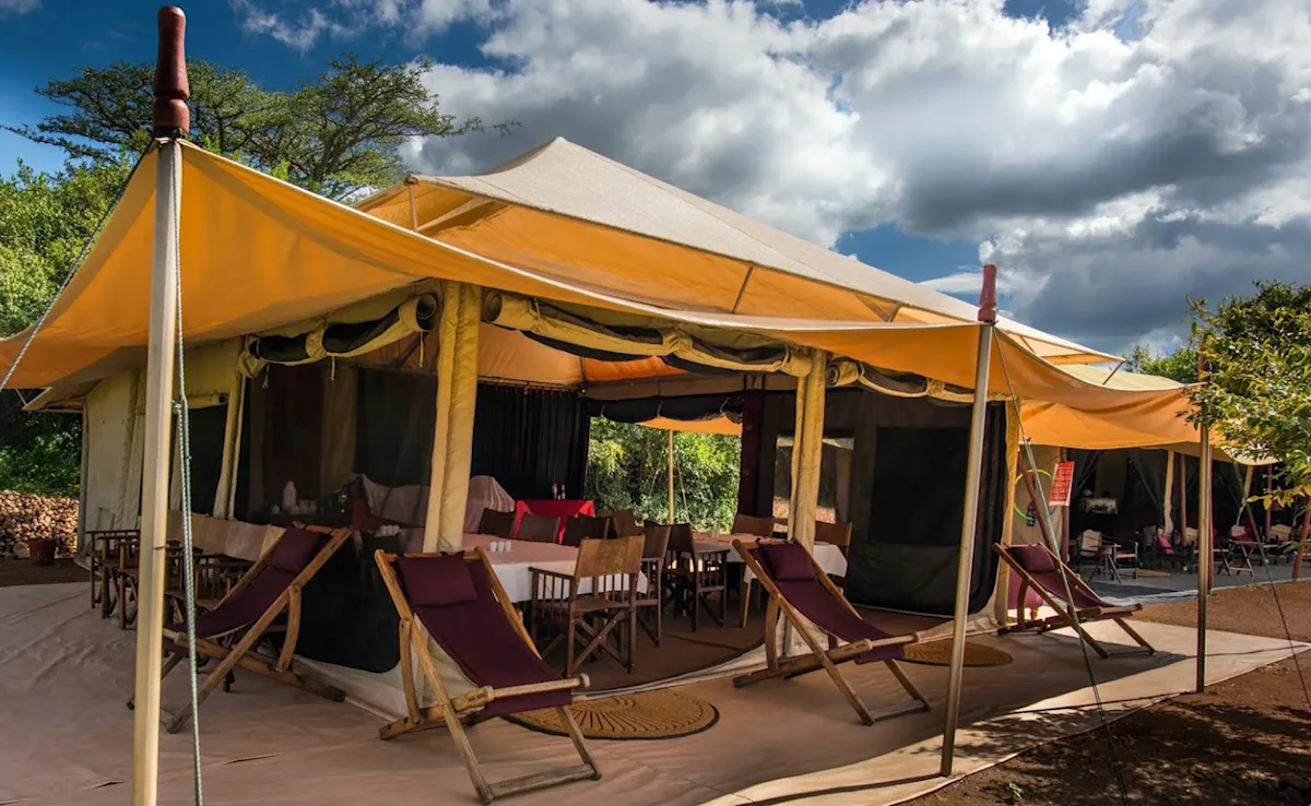 Dining tent with deck chairs out front at Eastern Serengeti Nyumba