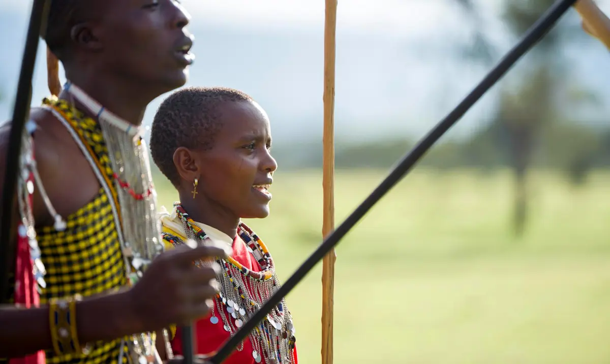 Maasai man and young woman in beaded jewelry during a cultural visit in the Eastern Serengeti