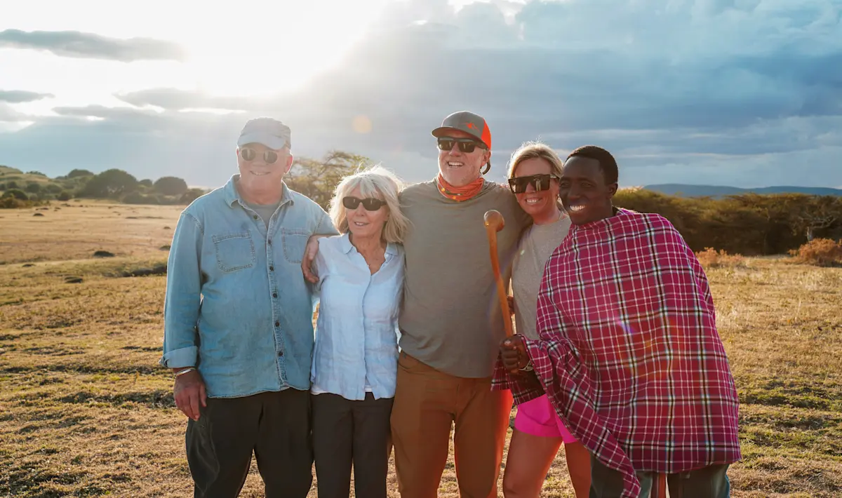 Thomson guests posing with their local guide on the savanna