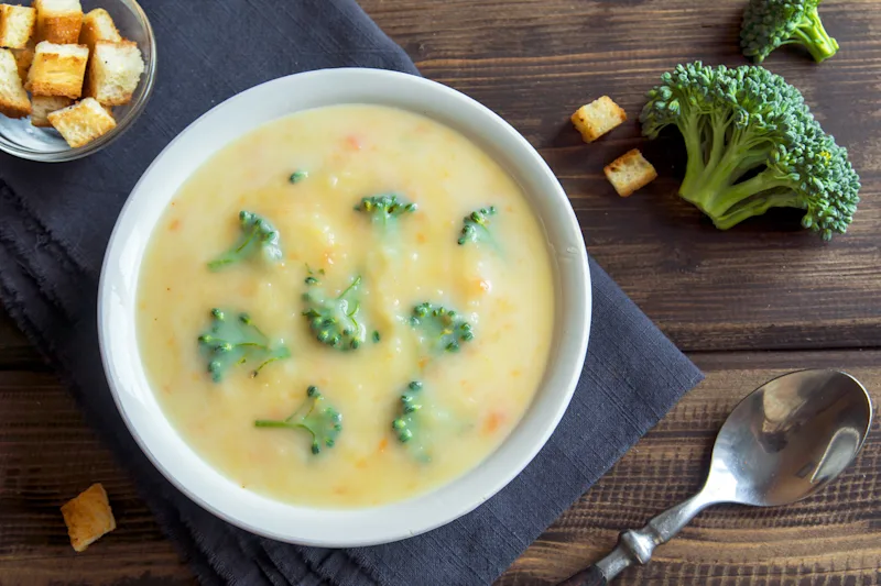 Bowl of broccoli Gruyère soup with croutons