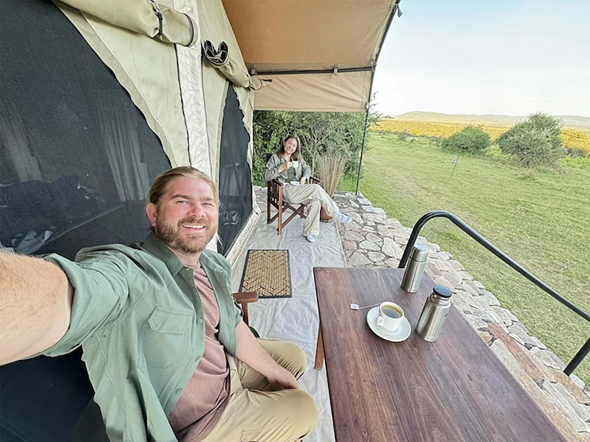 chris and his wife on veranda of tent at thomson safaris nyumba camp in serengeti