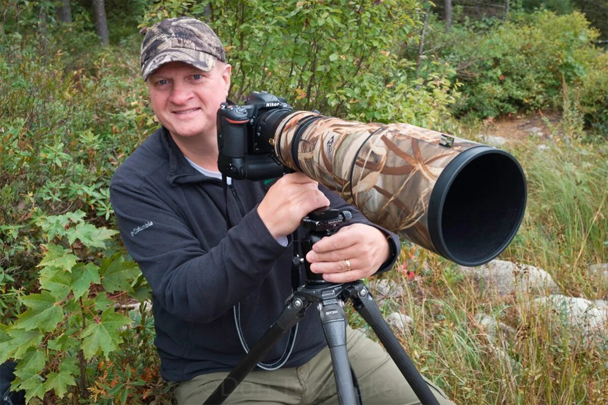 Photographer Don Toothaker with a camouflaged telephoto lens on a tripod