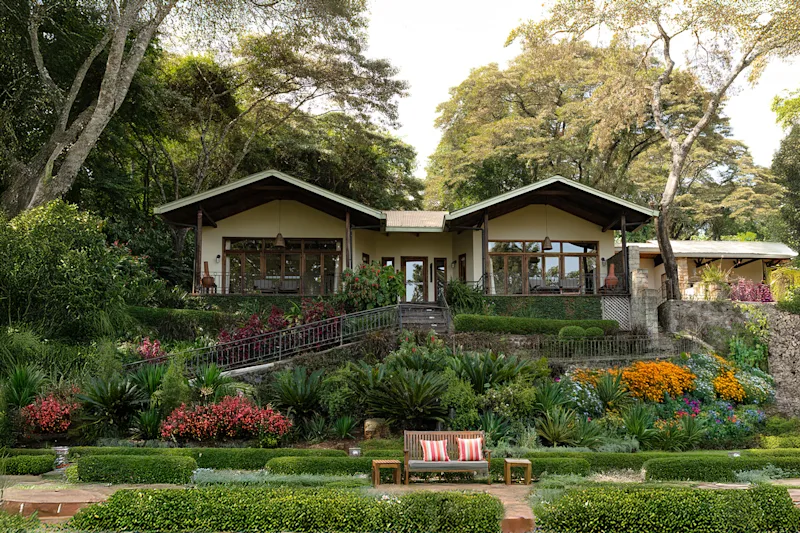 Bustani cottage and flowering gardens at Gibb's Farm