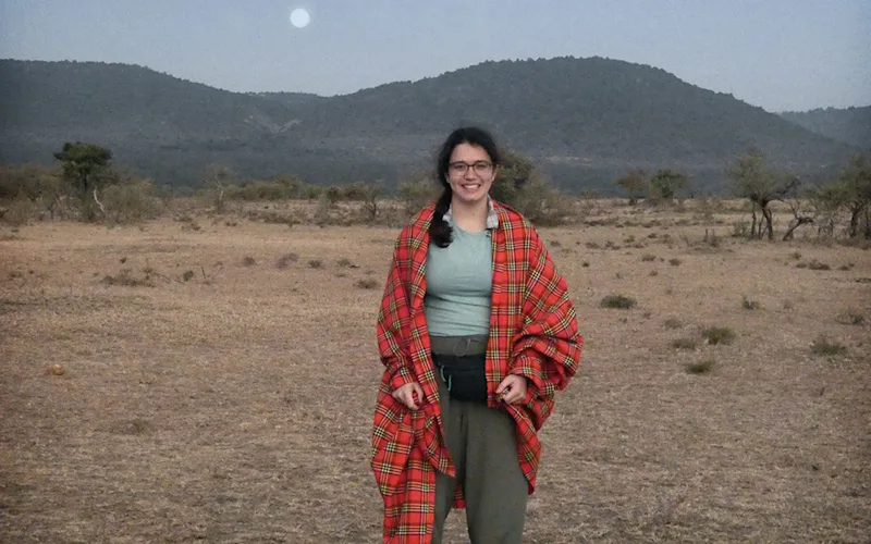 Thomson consultant Halee wrapped in a red Maasai shuka in the Eastern Serengeti at dusk
