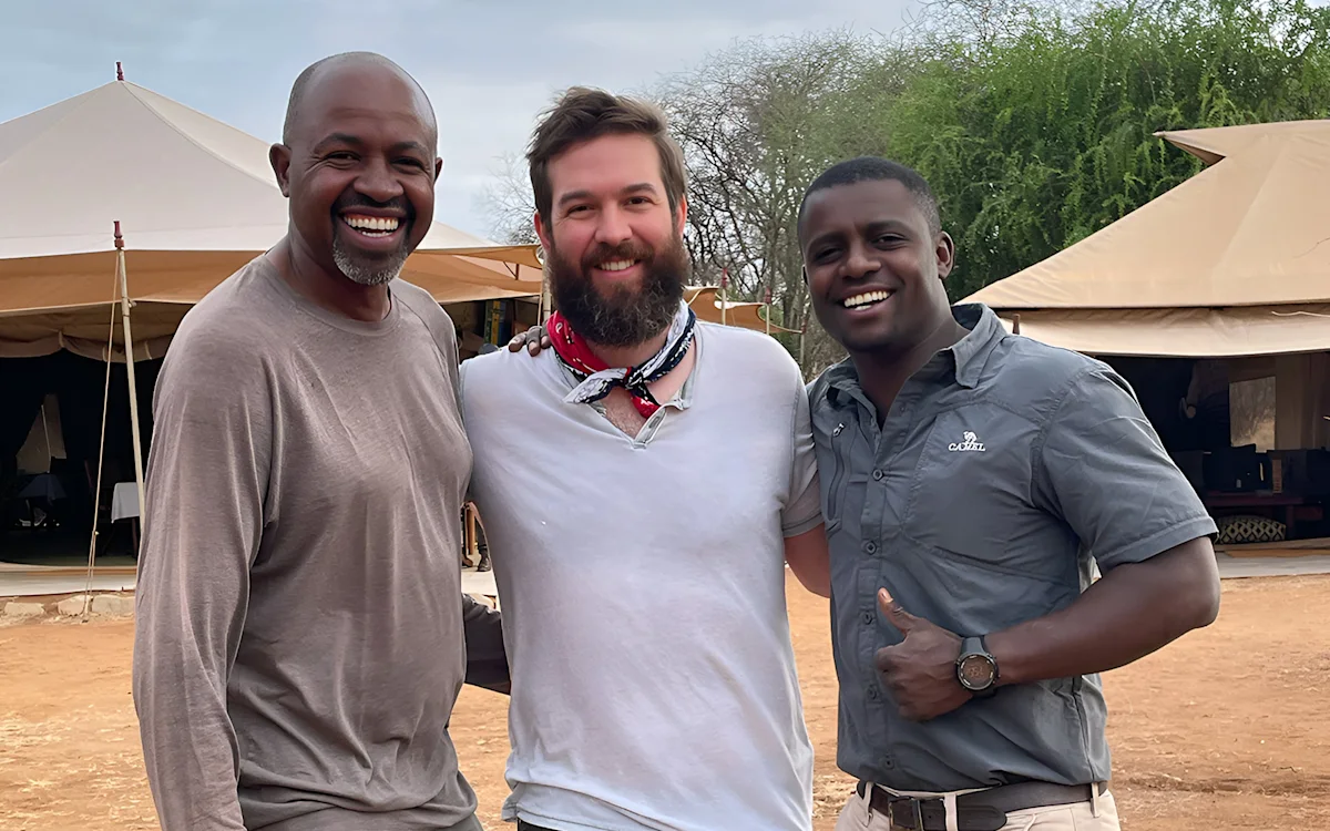 Thomson staffer Lewis with two Thomson Safaris guides at camp
