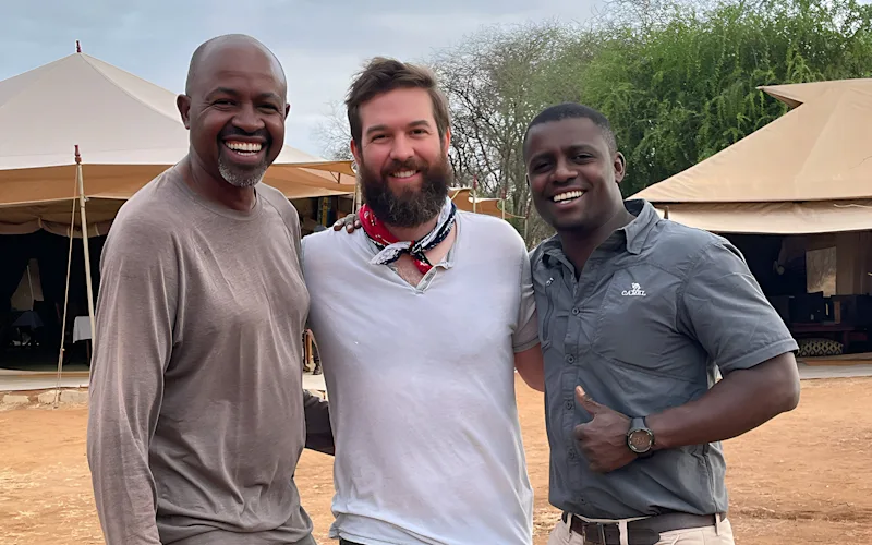 Thomson staffer Lewis with two Thomson Safaris guides at camp