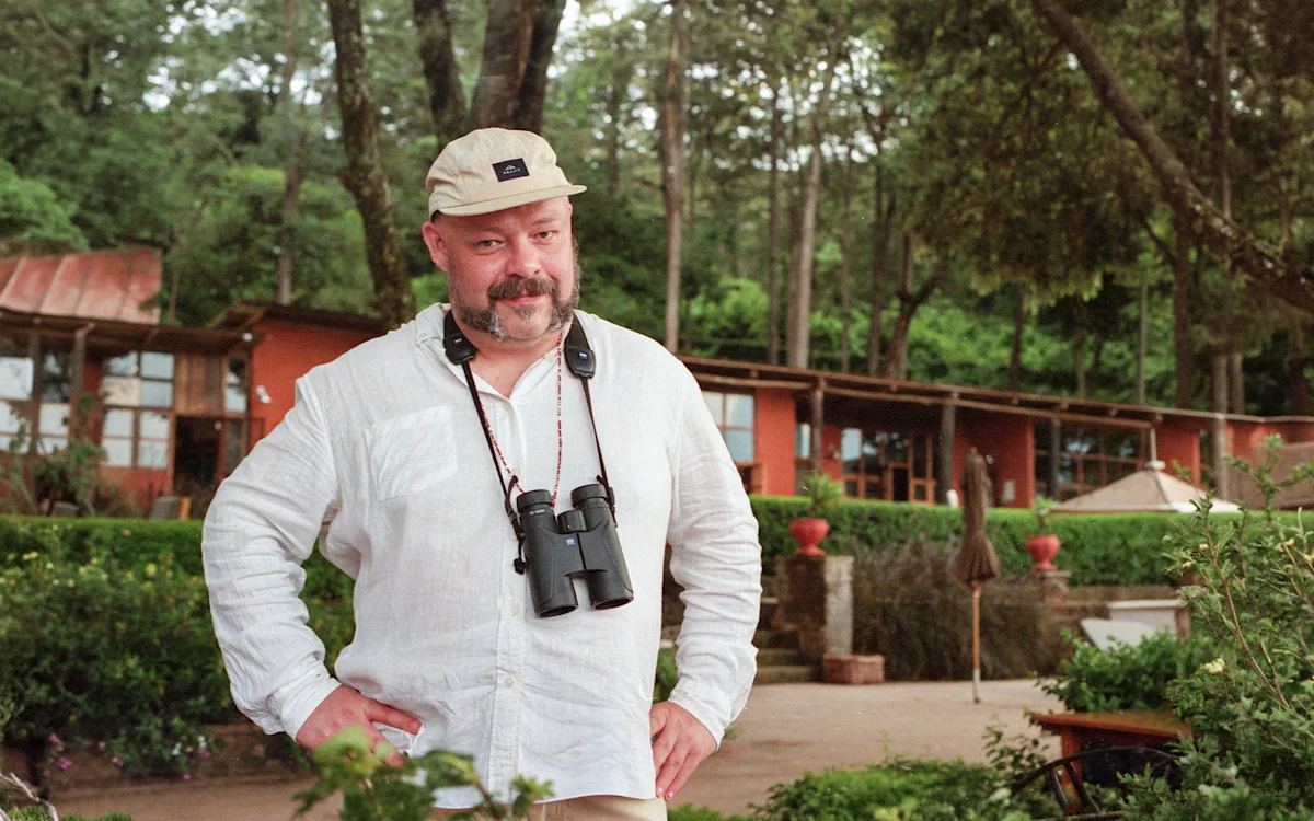 Andrew Doherty with binoculars at Gibb's Farm, Tanzania