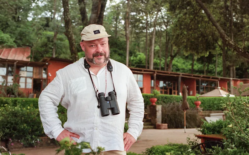Andrew Doherty with binoculars at Gibb's Farm, Tanzania
