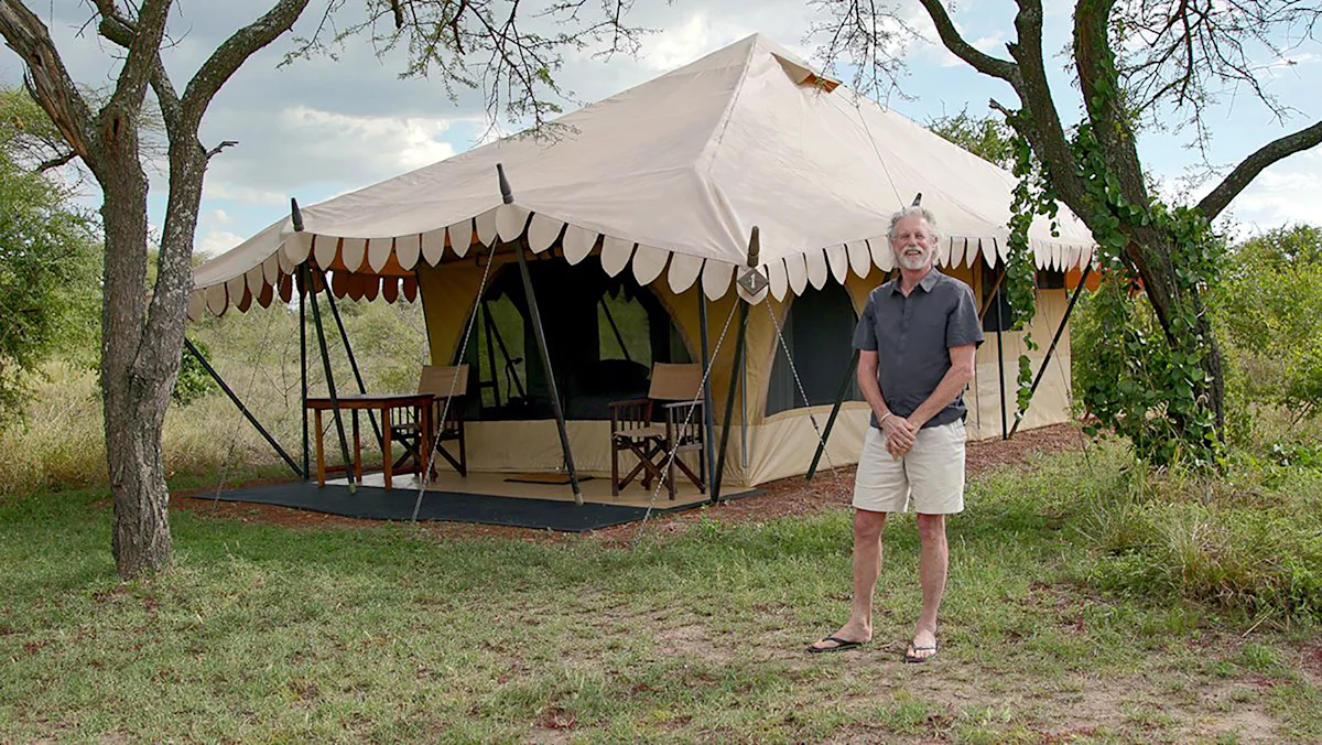 Rick Thomson standing outside a Thomson Nyumba safari tent