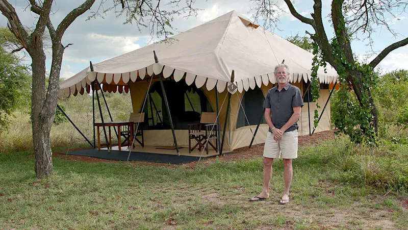 Rick Thomson standing outside a Thomson Nyumba safari tent