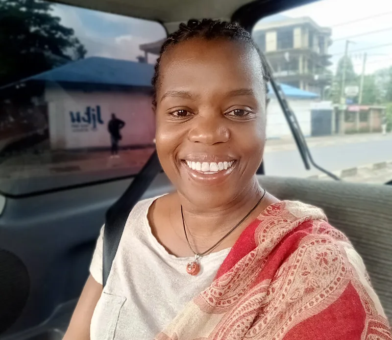 Rose Ngilisho, General Manager of Thomson Safaris in Tanzania, smiling in a vehicle