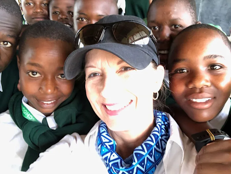 thomson guest with school children in tanzania