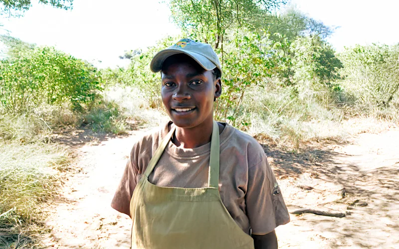 Thomson Nyumba camp chef Rebeka Maronde in an apron on a bush path