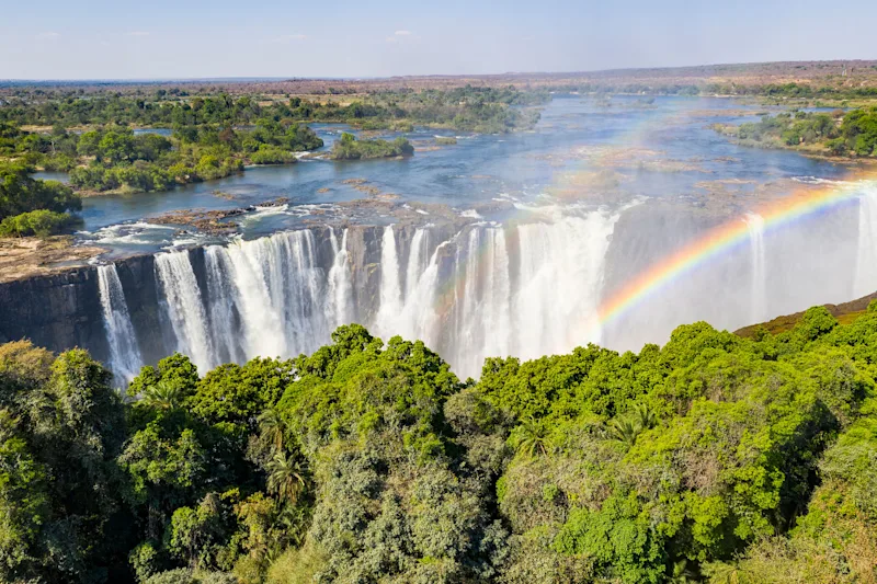 Rainbow over Victoria Falls and the river above the gorge