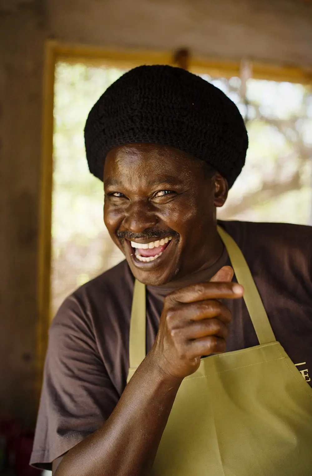 Laughing camp cook in an apron