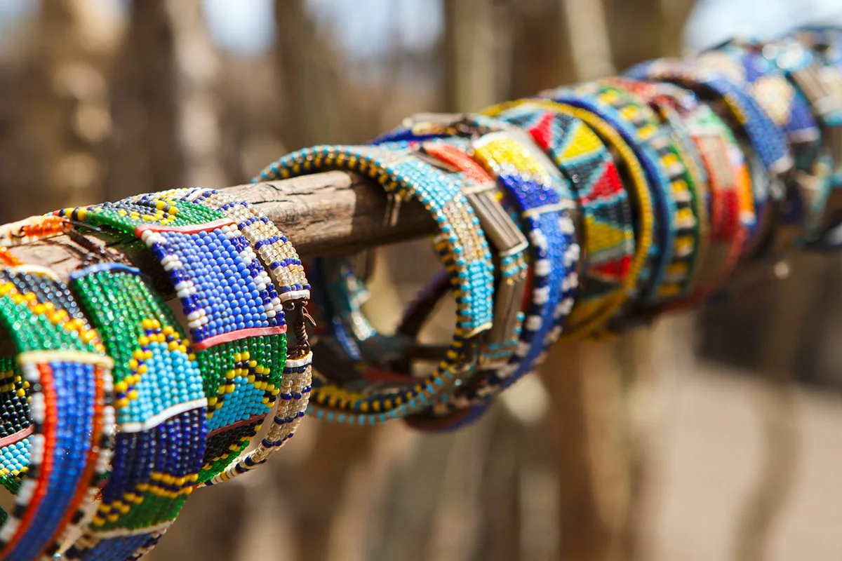 Colorful Maasai beaded bracelets hanging on a wooden pole