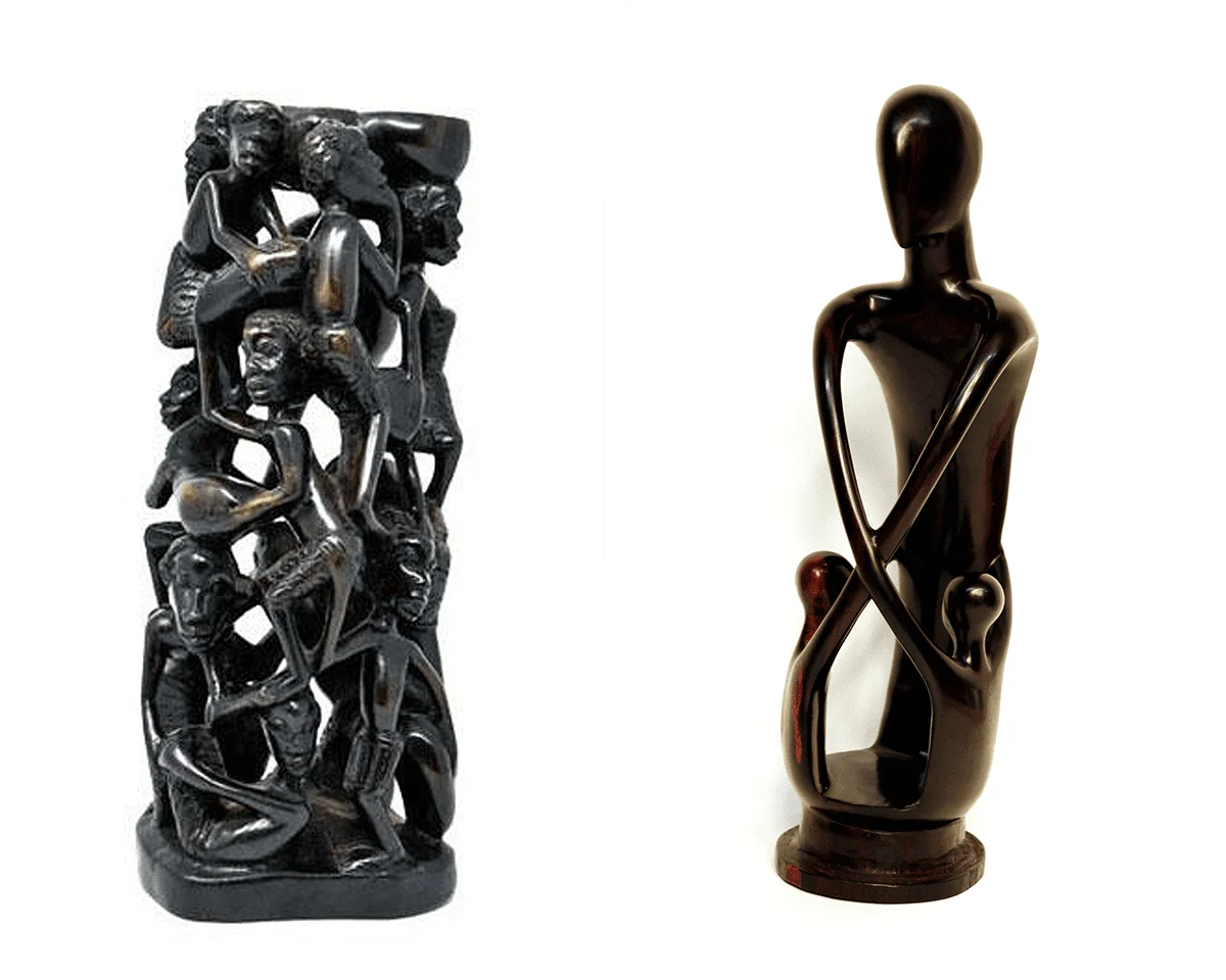 Two dark wood carvings: a tower of intertwined figures and a smooth abstract seated figure