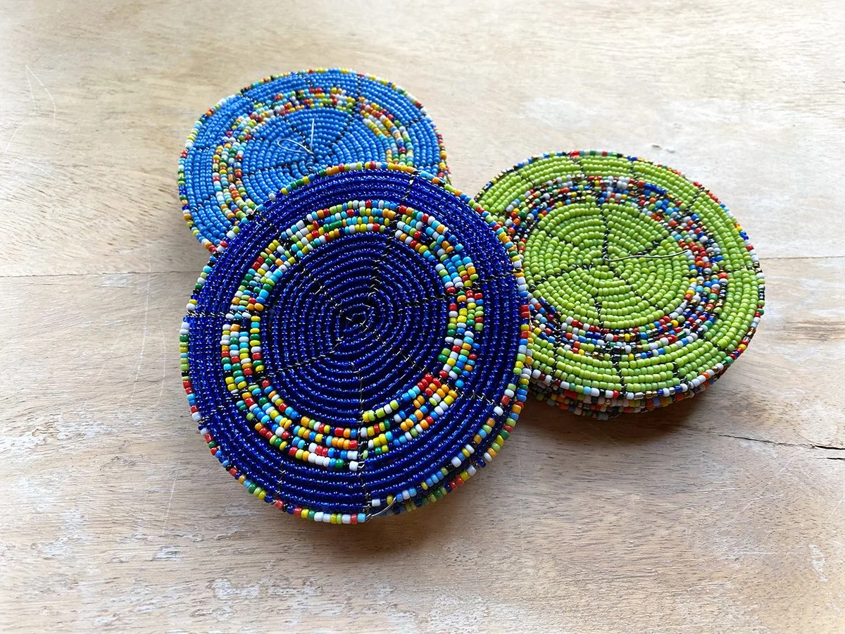 Three round Maasai beaded coasters in blue and green
