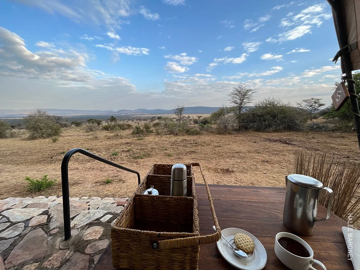 Morning coffee and biscuits on a tent veranda overlooking the dry savanna