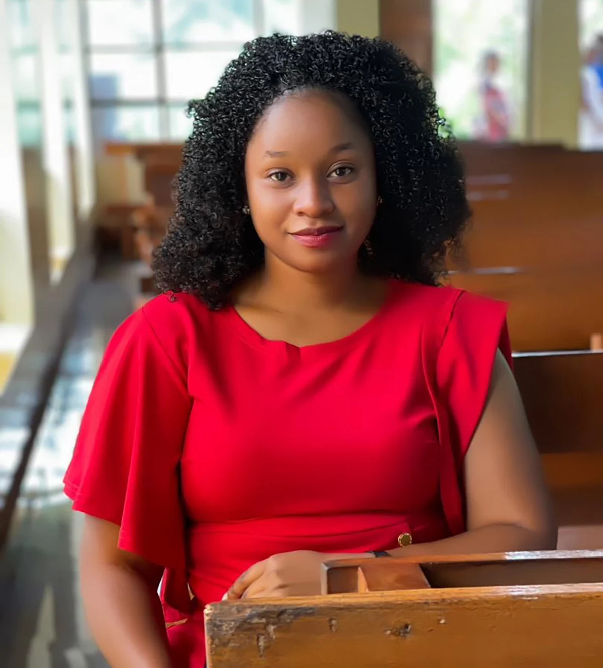 Portrait of Grace Kimaro in a red dress