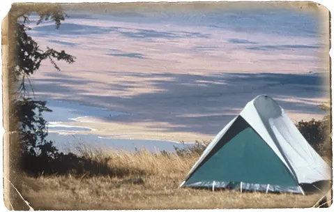 Vintage photo of a small A-frame tent on the Ngorongoro Crater rim above the crater floor