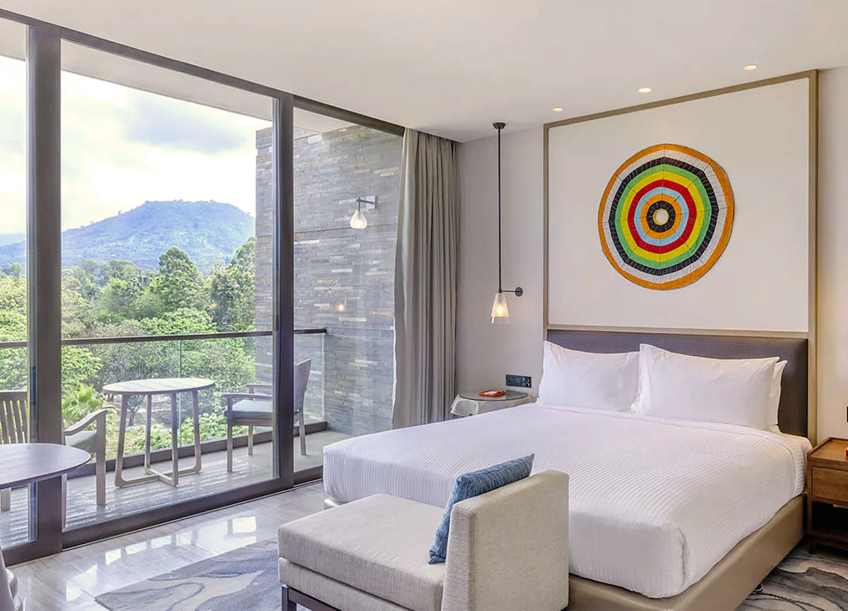 Guest room with floor-to-ceiling windows and a mountain view at Gran Melia Arusha