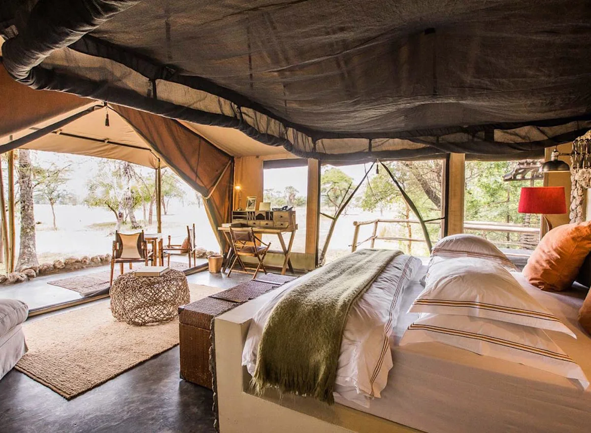 Tented suite with a large bed open to the bush at Chem Chem Lodge