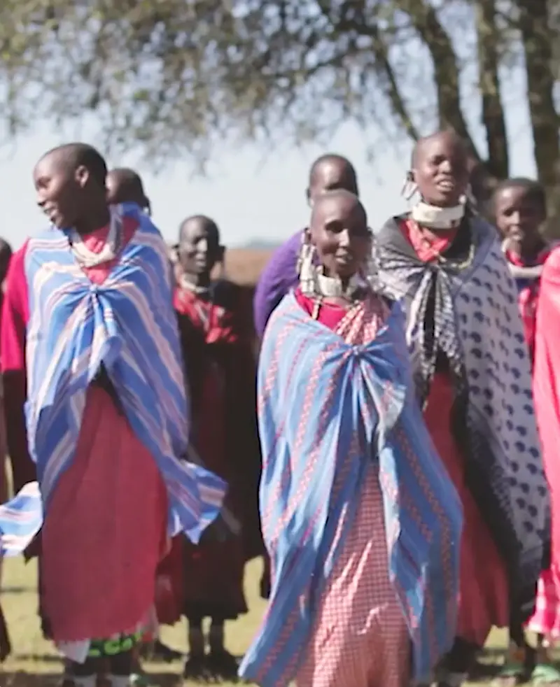 Maasai women in colorful shukas and beaded collars standing together